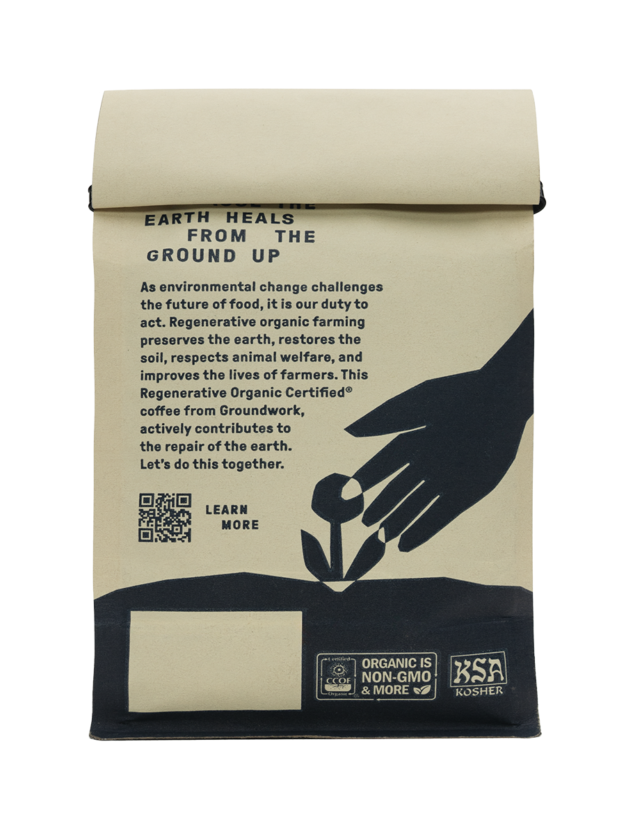 Back of Groundwork coffee bag with text promoting regenerative organic farming. Features a hand planting a flower illustration, QR code with ‘Learn more’, and certifications including Organic, Non-GMO, and Kosher.