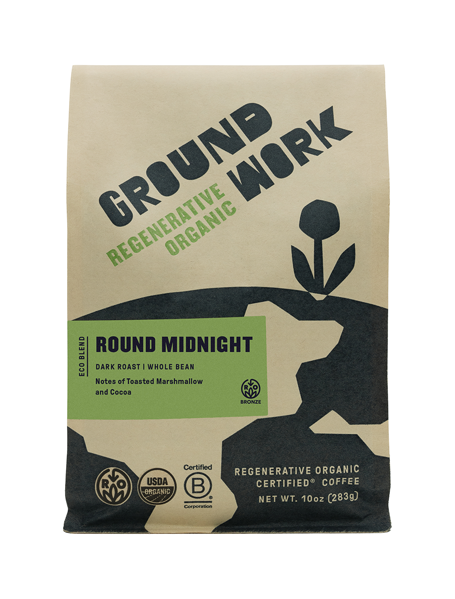 A beige and black 10oz bag of Groundwork Coffee Regenerative Organic Certified® Round Midnight, with certification logos and plant graphics; notes of cocoa and toasted marshmallow.