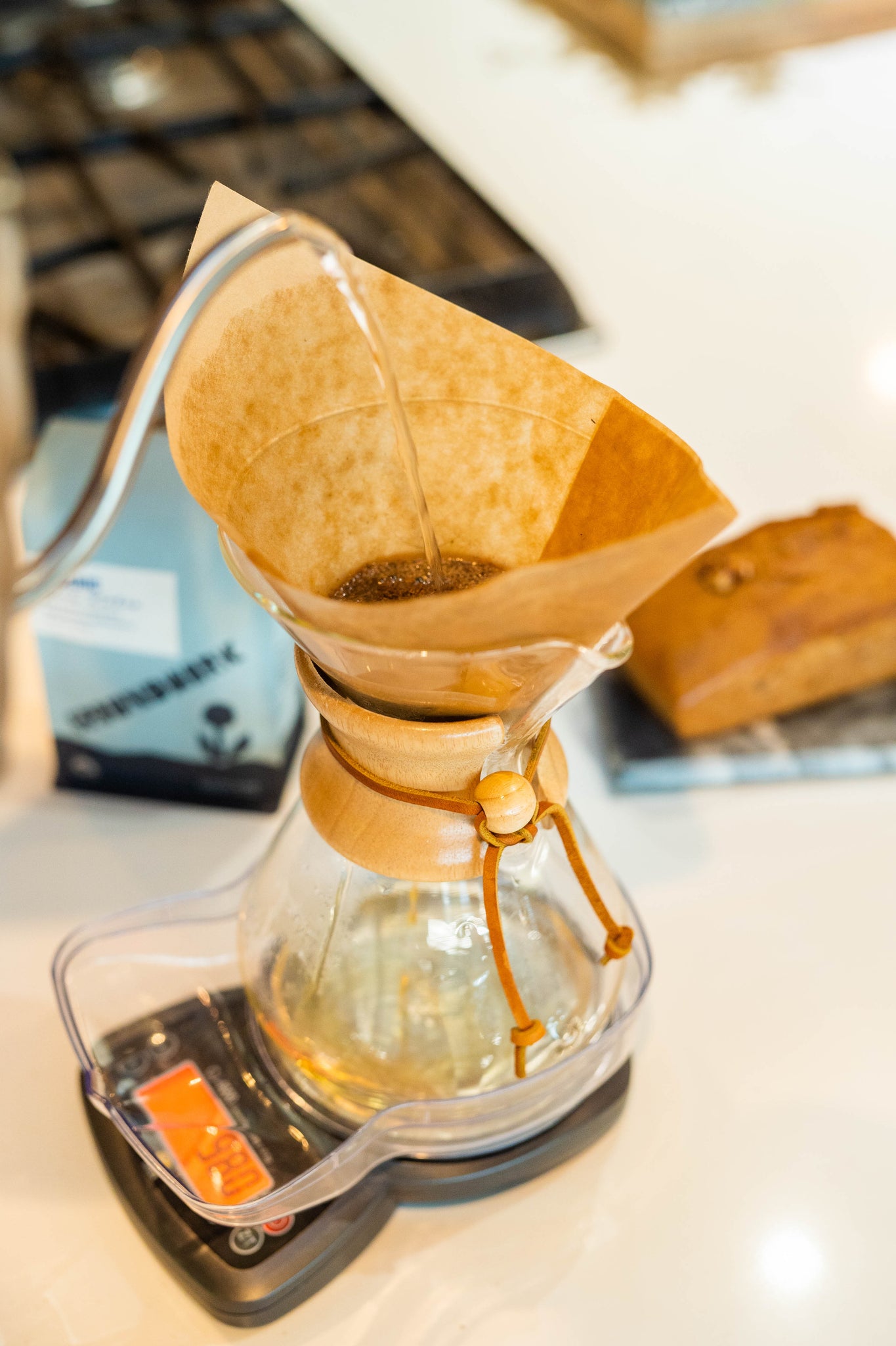 Chemex brewer on kitchen counter, brewing seasonal select coffee with a kettle