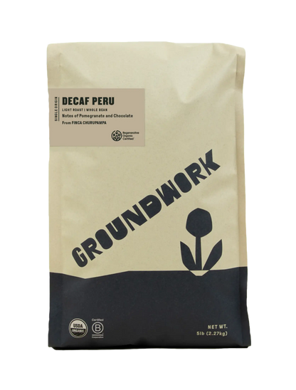 Five-pound bag of Regenerative Organic Certified® Decaf Peru whole bean coffee with a label listing notes of pomegranate and chocolate.