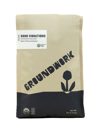 A 5 lb bag of Groundwork Coffee Regenerative Organic Certified® Good Vibrations medium roast whole beans offers vibrant citrus and apricot notes in a tan and black design.