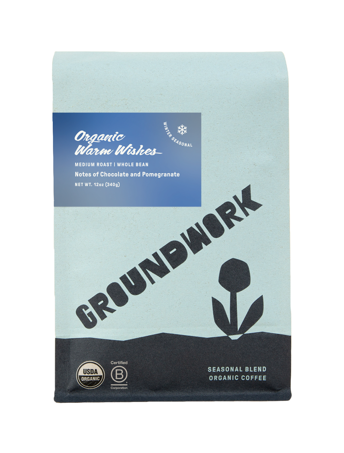 Groundwork Organic Warm Wishes winter seasonal coffee bag in light blue packaging with a blue label and tulip graphic. Text reads “Organic Warm Wishes,” “Medium Roast,” “Whole Bean,” “Notes of Chocolate and Pomegranate,” and “Net Wt 12oz (340g)” with USDA Organic and Certified B Corp seals shown at the bottom.