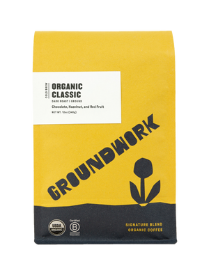 A yellow and black bag of Groundwork Coffee Store Cold Brew Blend with a tulip graphic, certification labels, and dark chocolate notes on the front.