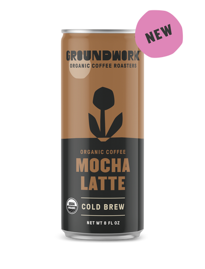 An 8 fl oz can of Groundwork Coffee Organic Cold Brew Latte with a black flower graphic and a pink "NEW" label in the top right corner.