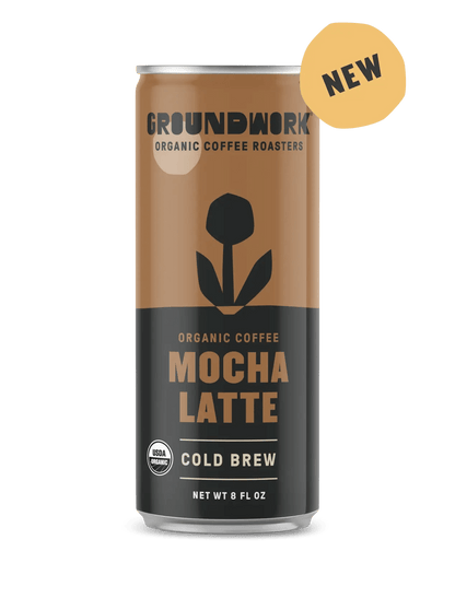 An 8 fl oz can of Groundwork Coffee Organic Cold Brew Latte with a flower design, a "NEW" label, and USDA organic certification.