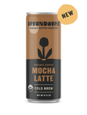 An 8 fl oz can of Groundwork Coffee Organic Cold Brew Latte with a flower design, a "NEW" label, and USDA organic certification.