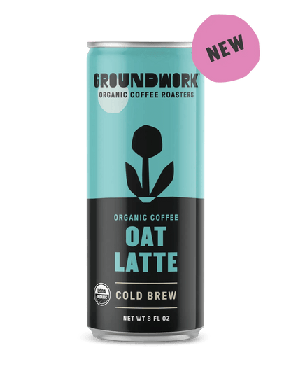 A can of Groundwork Coffee Organic Cold Brew Latte with a blue and black design and a NEW pink label in the corner.