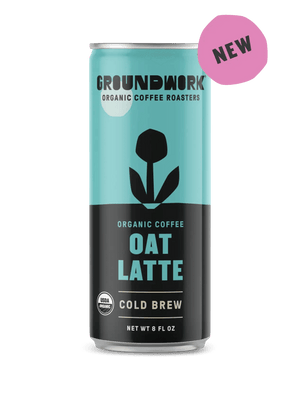 A can of Groundwork Coffee Organic Cold Brew Latte with a blue and black design and a NEW pink label in the corner.