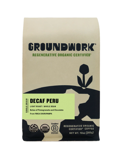 A bag of Regenerative Organic Certified® Decaf Peru medium roast decaf whole bean coffee with pomegranate and chocolate flavor notes.