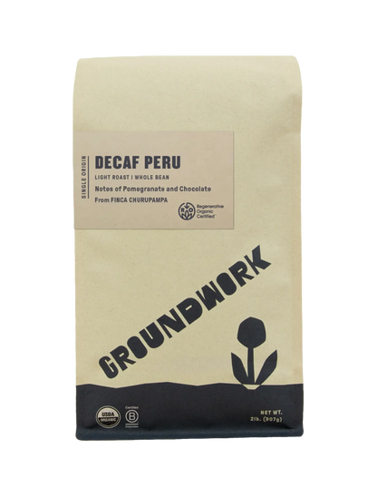 A bag of Groundwork Coffee Regenerative Organic Certified® Decaf Peru whole bean coffee with notes of pomegranate and chocolate, featuring USDA Organic and B Corp certification logos.