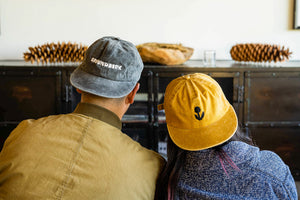 Guy and girl wearing Groundwork hat in front of the TV