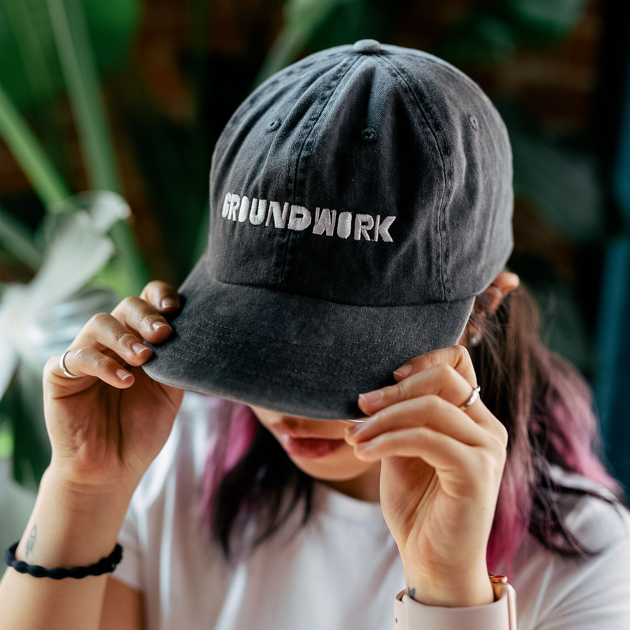Girl wearing An unstructured 6-panel cotton hat with embroidered groundwork logo 